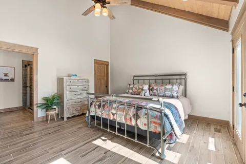 a bedroom with a bed and a chandelier