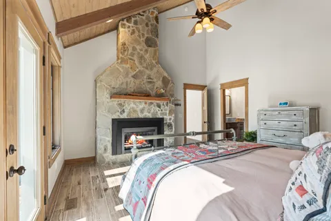 a bedroom with a bed and a fireplace