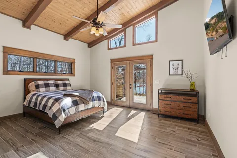 a bedroom with a bed and wooden floor