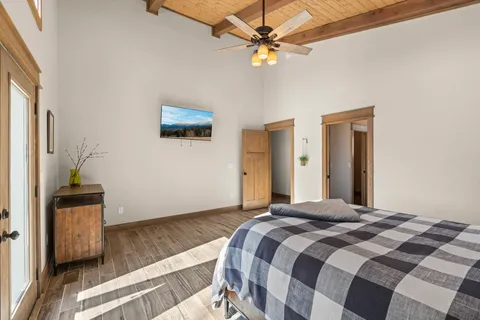 a bedroom with a bed and a chandelier