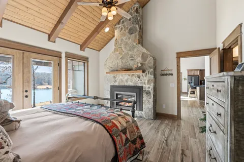 a spacious bedroom with a bed and a fireplace