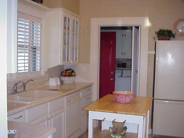 3605 South Hayden Street Amarillo, TX 79110 - Photo 4 of 4 a kitchen with a sink cabinets and refrigerator