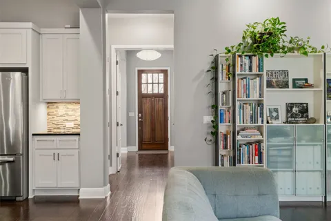 a living room with furniture and a book shelf