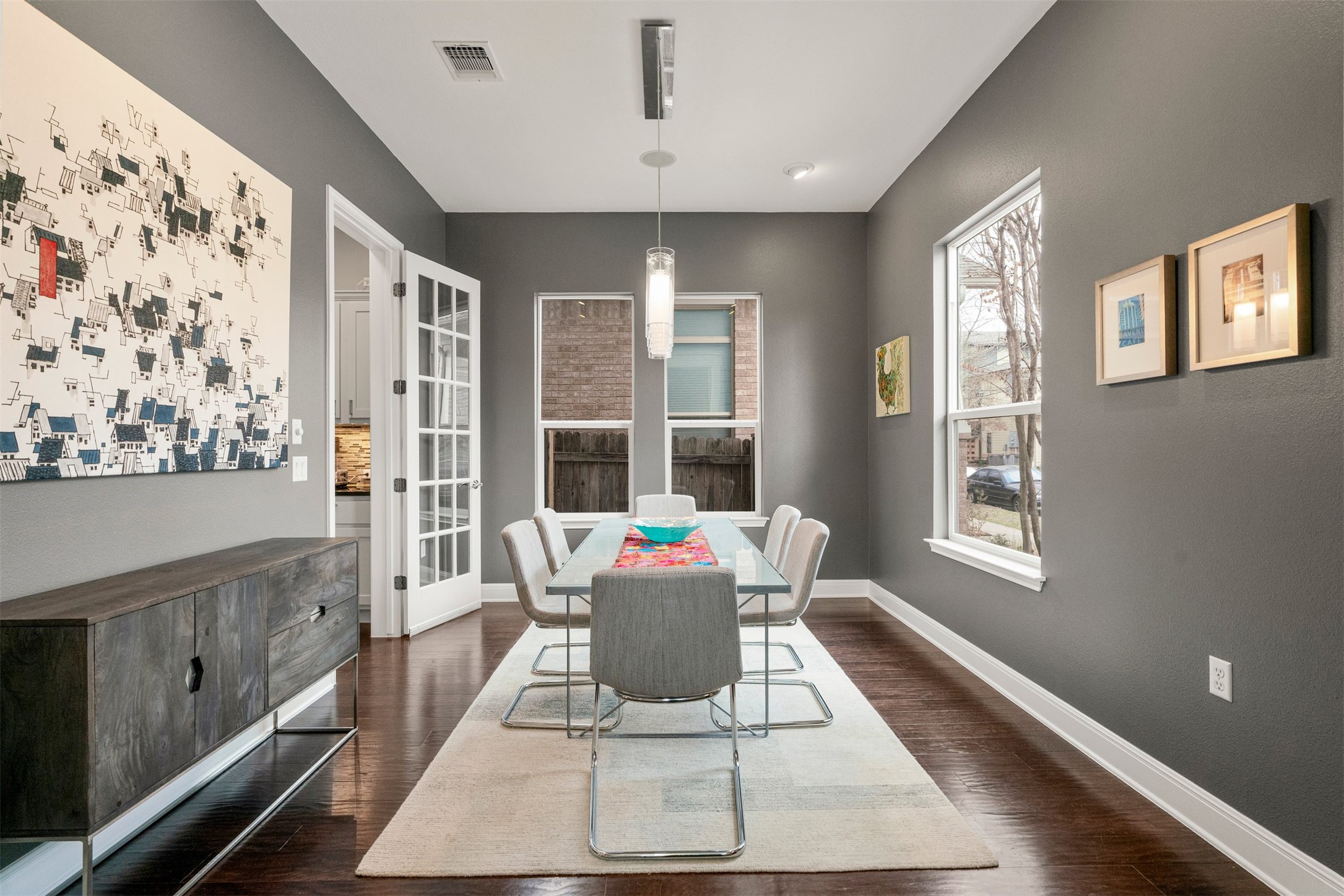 4512 Ruiz Street Austin, TX 78723 - Photo 2 of 40 Just off the front entry, the flex space is currently arranged as a dining room, creating a welcoming spot for shared meals while still offering the flexibility to adapt the room to suit changing needs over time