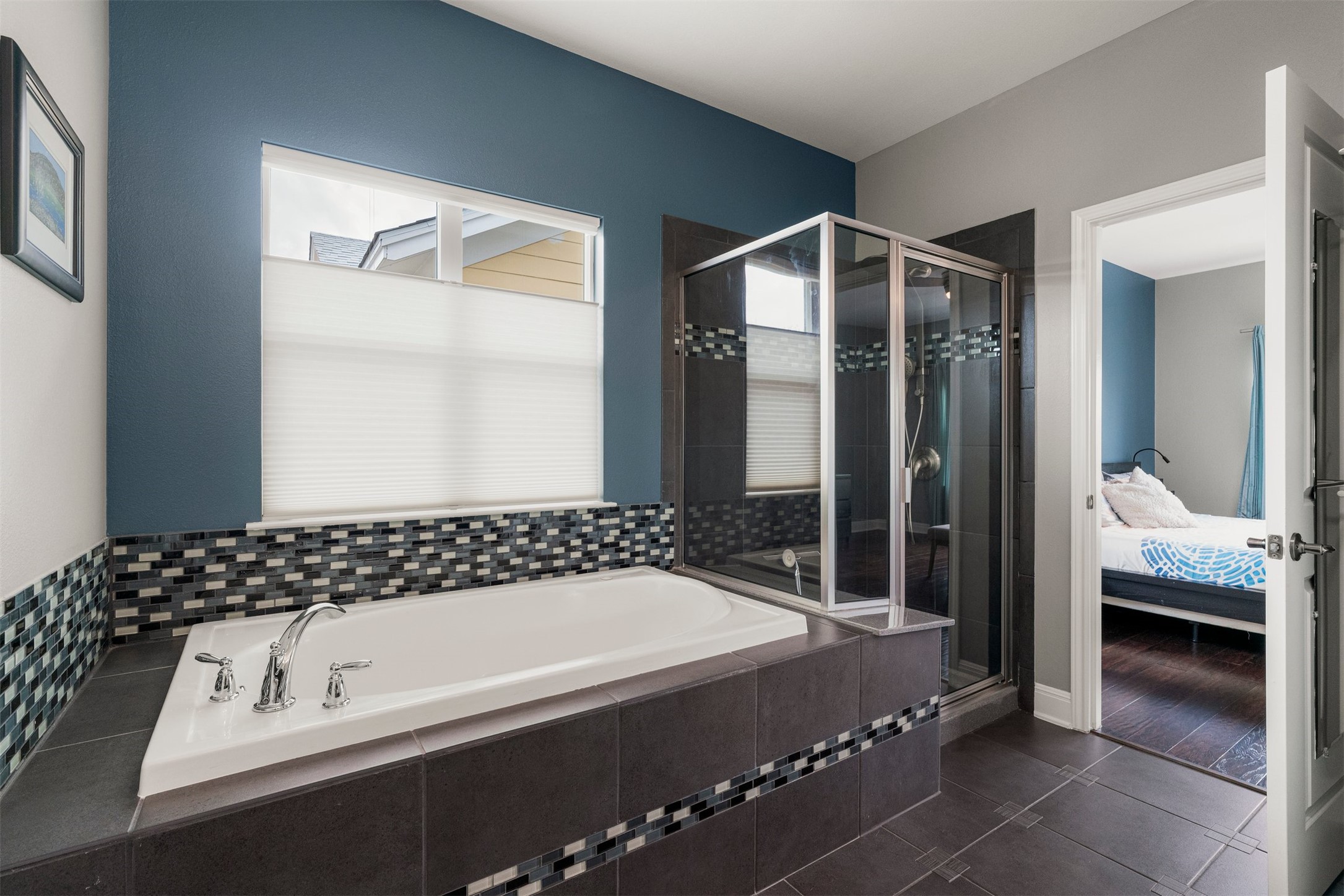 4512 Ruiz Street Austin, TX 78723 - Photo 27 of 40 A soaking tub and separate walk in shower create a comfortable setup within the primary bathroom, offering options for a quick start to the day or a slower evening routine