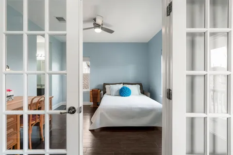 a bedroom with a bed and wooden floor