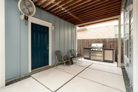 a view of a patio with table and chairs and potted plants