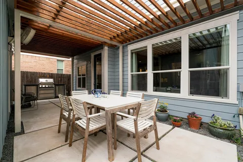 a view of a patio with table and chairs and potted plants