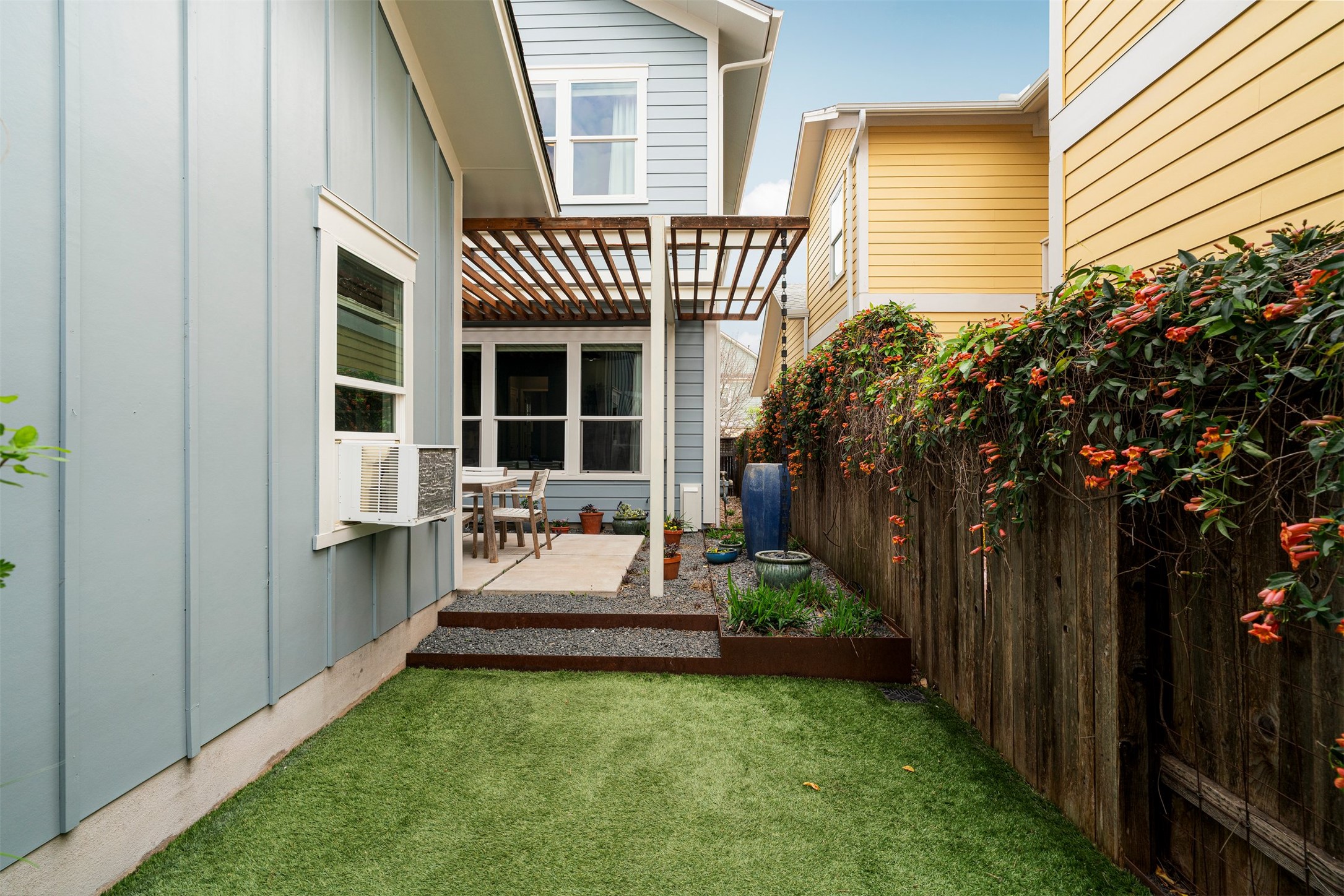 4512 Ruiz Street Austin, TX 78723 - Photo 8 of 40 The backyard features professionally installed turf paired with landscaped borders, creating a clean and low maintenance outdoor space that stays green year round