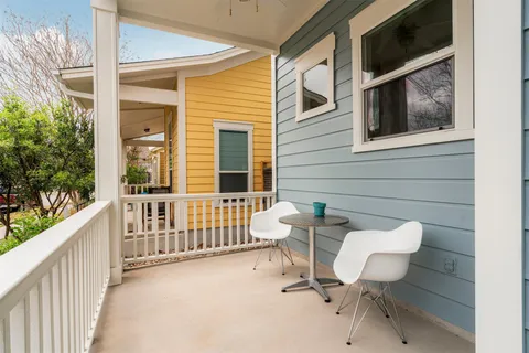 a view of a chair and table in the balcony