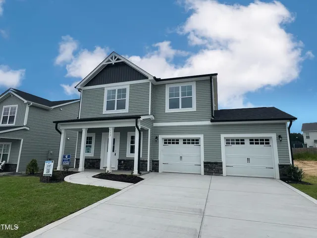 a front view of a house with a yard and garage