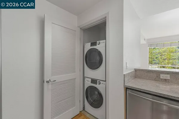 a view of walk in closet and bedroom