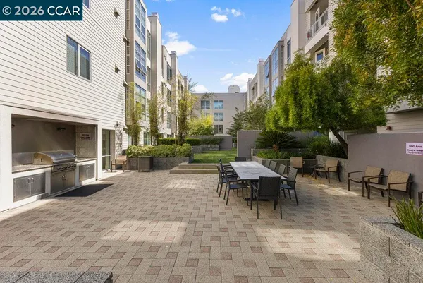a view of a patio with table and chairs