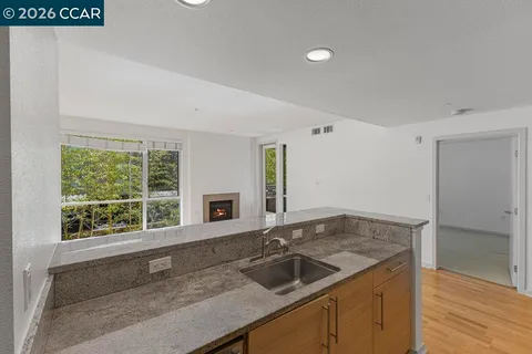 a kitchen with a sink and large window