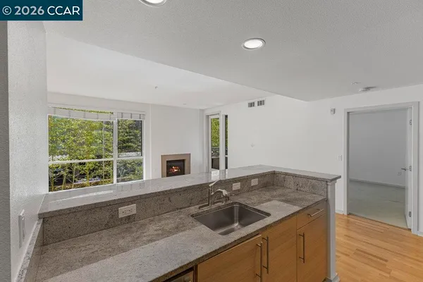 a kitchen with a sink and large window