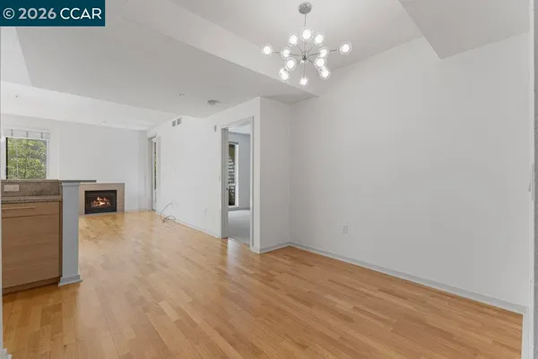 a view of a livingroom with a kitchen counter tops and empty room