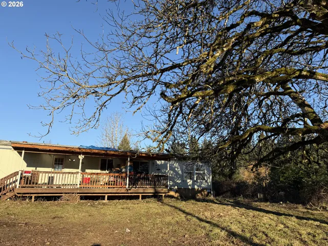 a view of a patio with table and chairs with wooden fence and plants