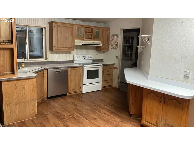 a kitchen with a sink cabinets and stainless steel appliances