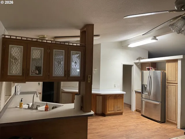 a kitchen with stainless steel appliances a refrigerator and a stove