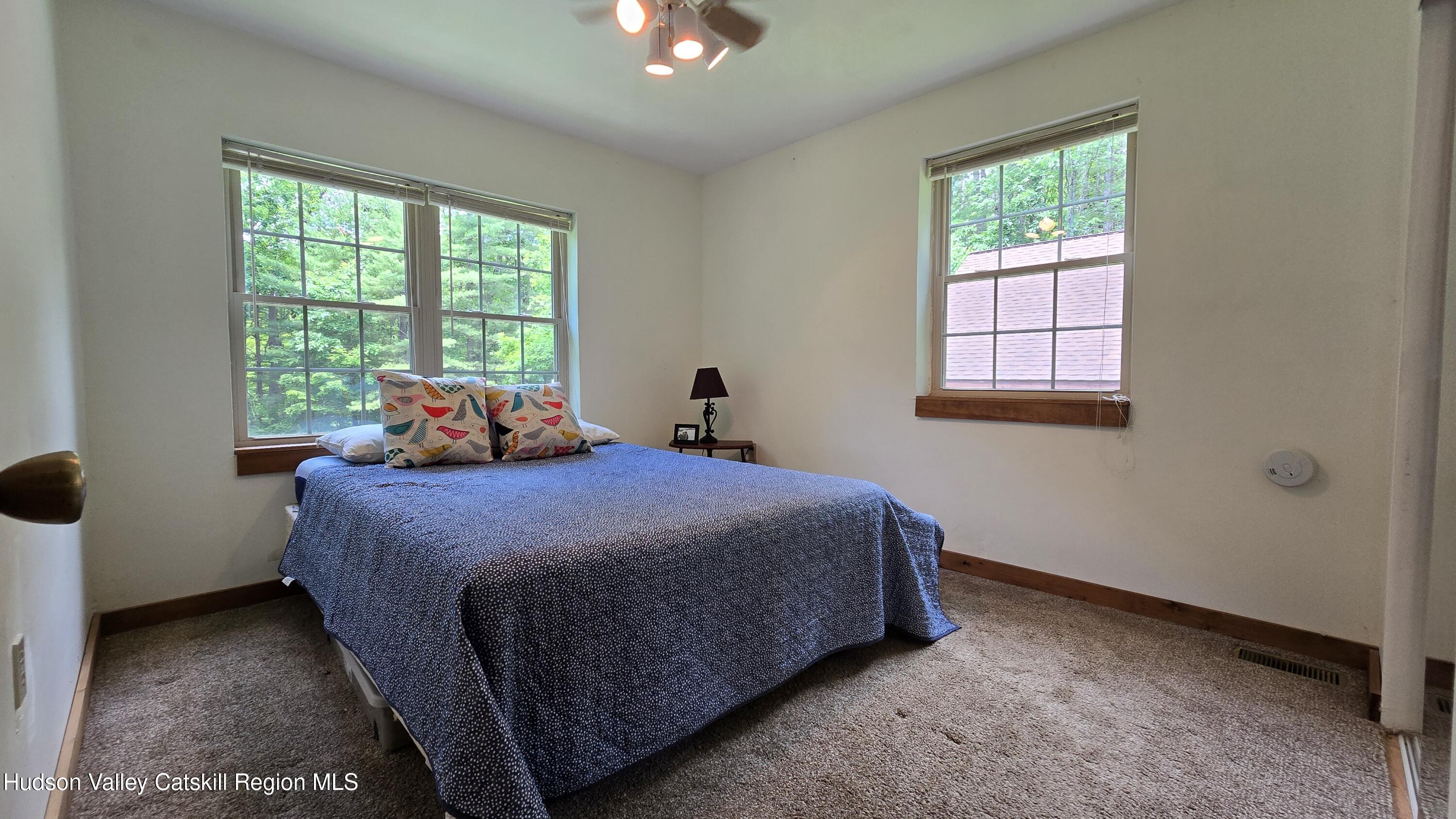 3620 County Rte 9 East Chatham, NY 12060 - Photo 18 of 28 a bed sitting in a bedroom next to a window