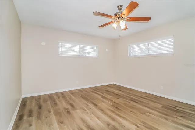 a view of room with window and ceiling fan