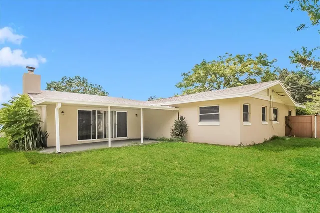 a view of an house with backyard space and garden