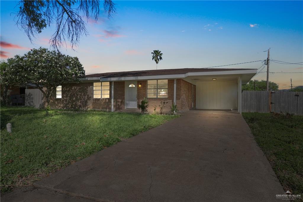 1109 Bluebonnet Harlingen, TX 78550 - Photo 1 of 1 Single story home with a carport, a front yard, fence, brick siding, and concrete driveway