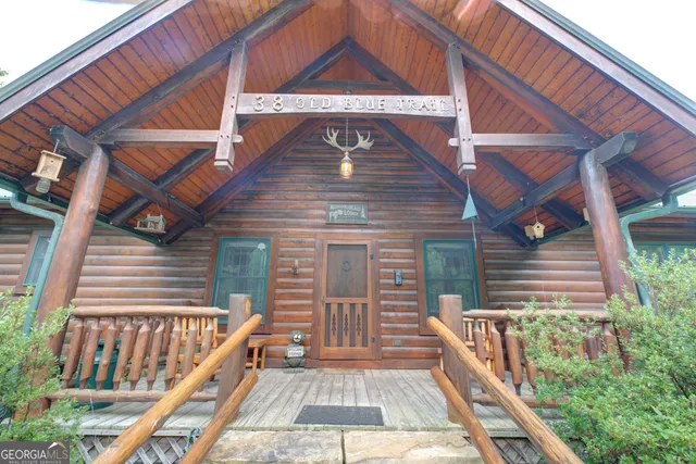 a view of a green field with a tree in the background