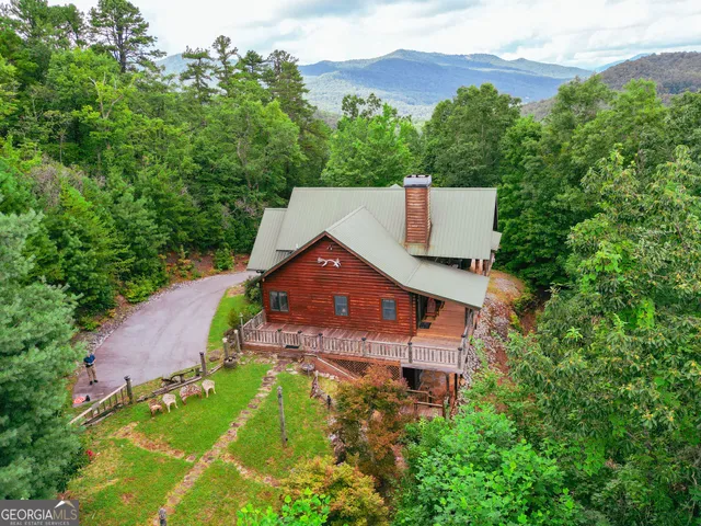 a view of a patio with table and chairs under an umbrella with wooden floor