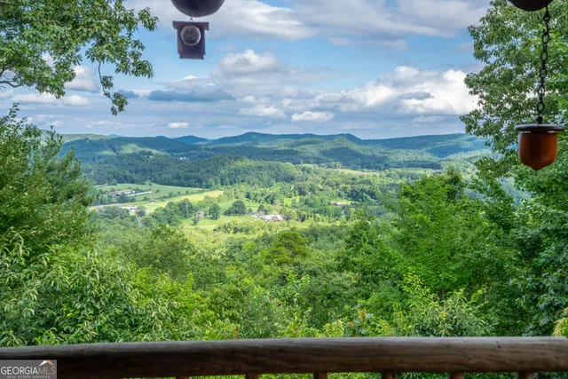 a view of a balcony with chairs and wooden floor