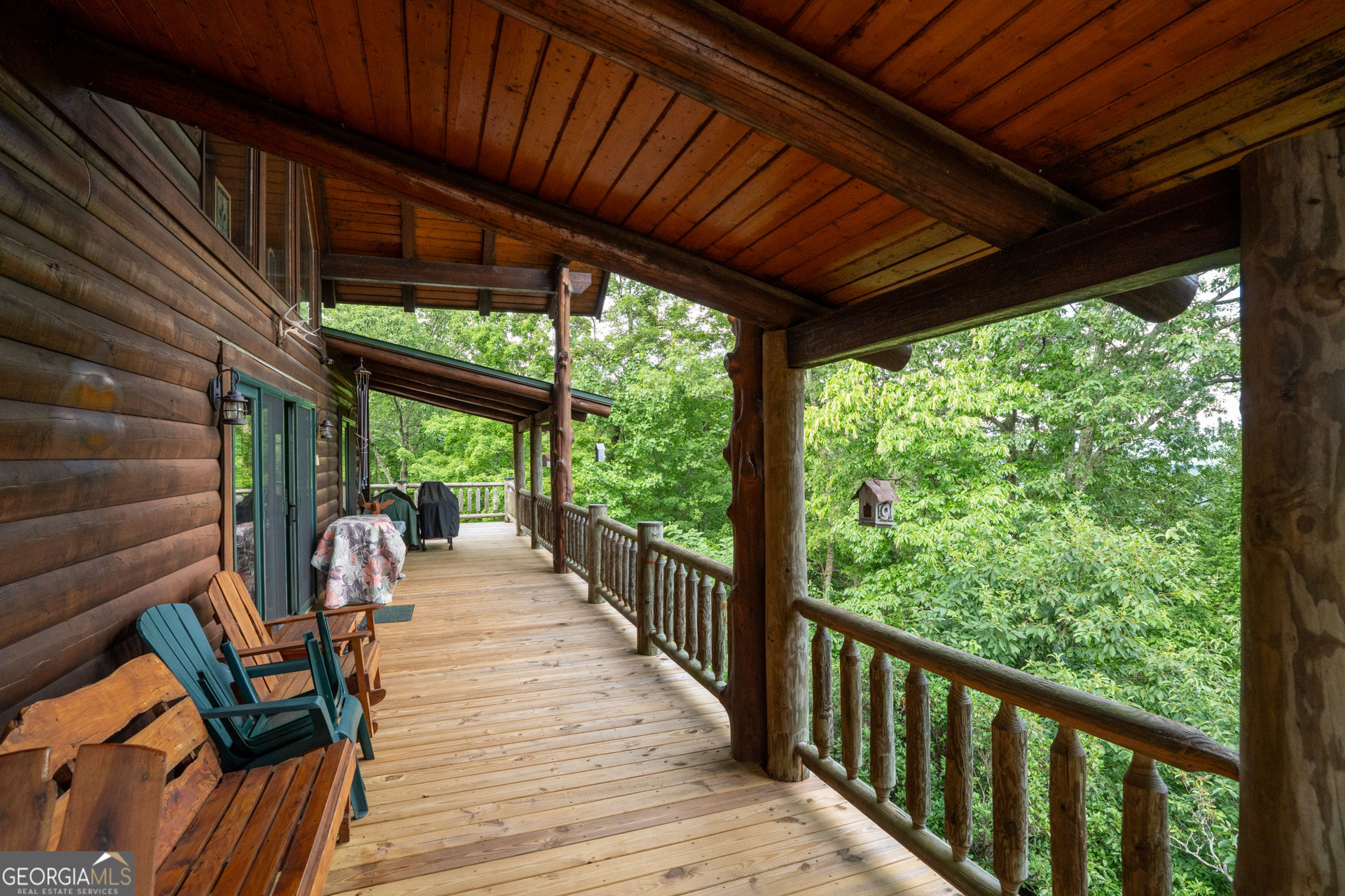 38 Old Blue Trail Tiger, GA 30576 - Photo 17 of 72 a view of a patio with table and chairs under an umbrella with wooden floor