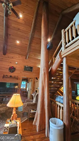 a bedroom with a bed a flat screen tv and a fireplace with the outer view