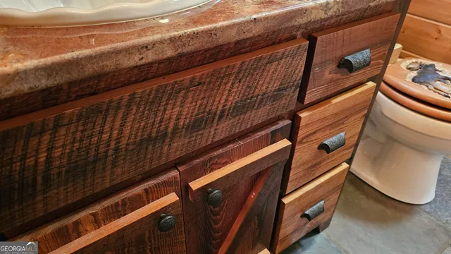 a bathroom with a tub a sink and mirror