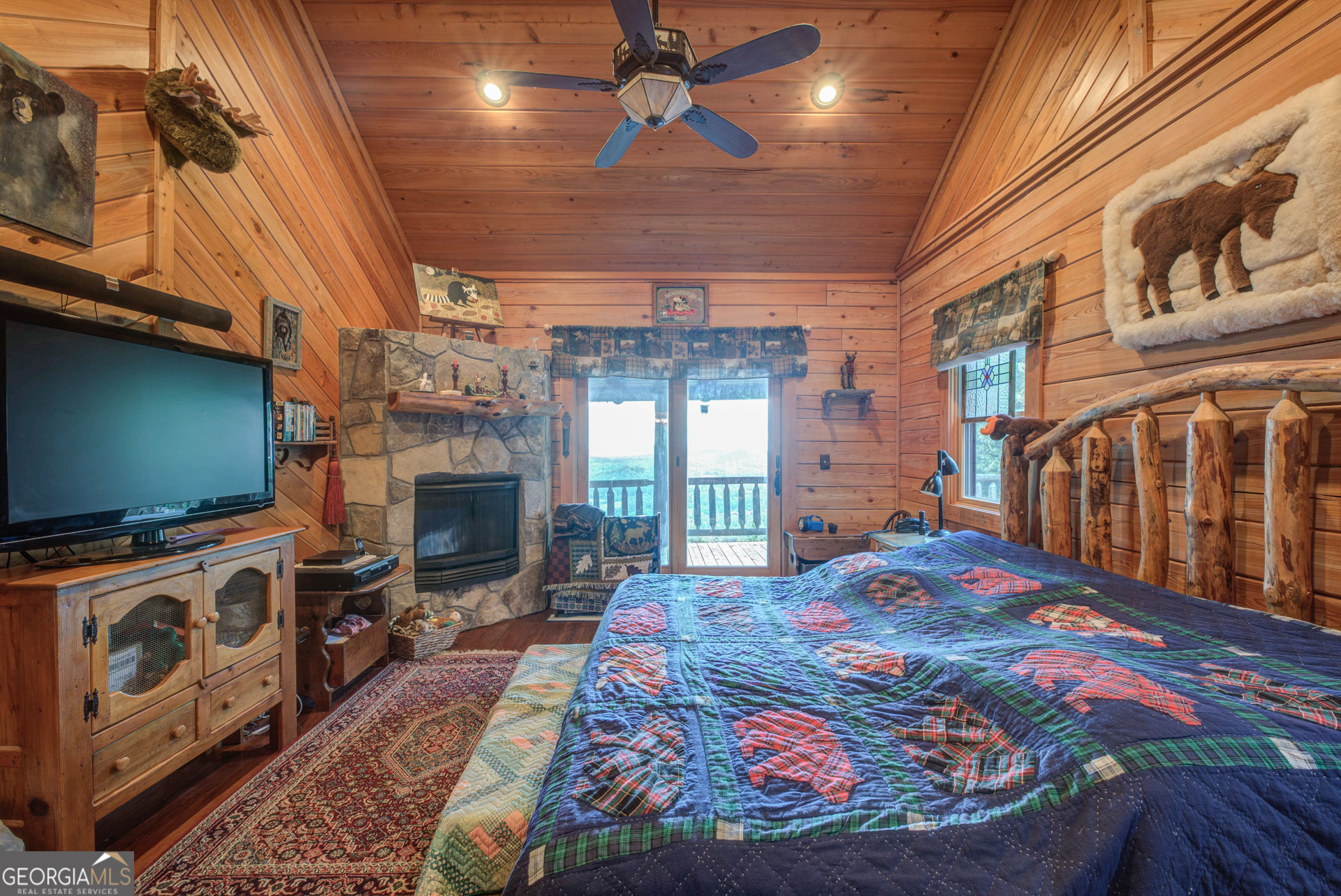 38 Old Blue Trail Tiger, GA 30576 - Photo 48 of 72 a bedroom with a bed a flat screen tv and a fireplace with the outer view