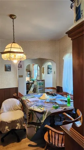 a bedroom with bed and a chandelier