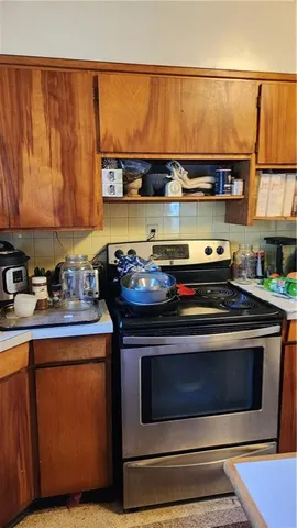 a stove top oven sitting inside of a kitchen