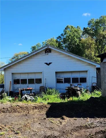 a front view of a house with plants