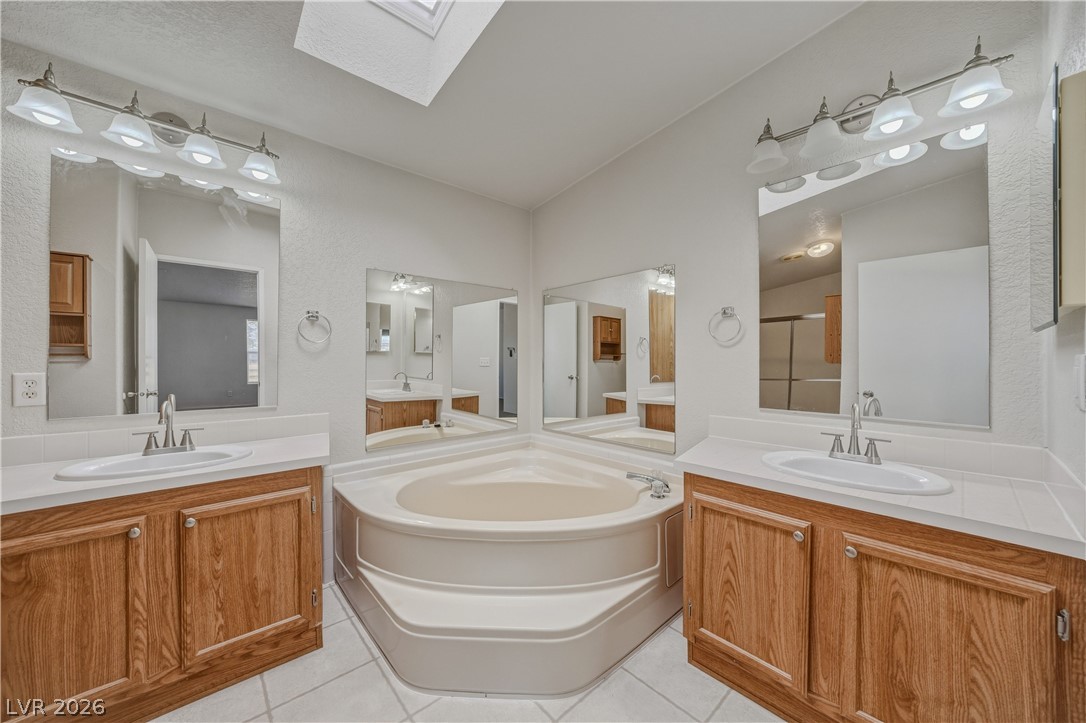 1890 West Dyer Road Pahrump, NV 89048 - Photo 9 of 40 This bright bathroom features a spacious soaking tub, double vanity, and ample natural light.