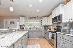 126 Norton's Fish Camp Road Satsuma, FL 32189 - Photo 5 of 25 a kitchen with stainless steel appliances granite countertop a sink a stove top oven a counter space and cabinets