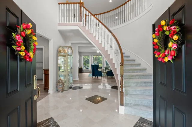 a kitchen with stainless steel appliances granite countertop a refrigerator a stove and a sink