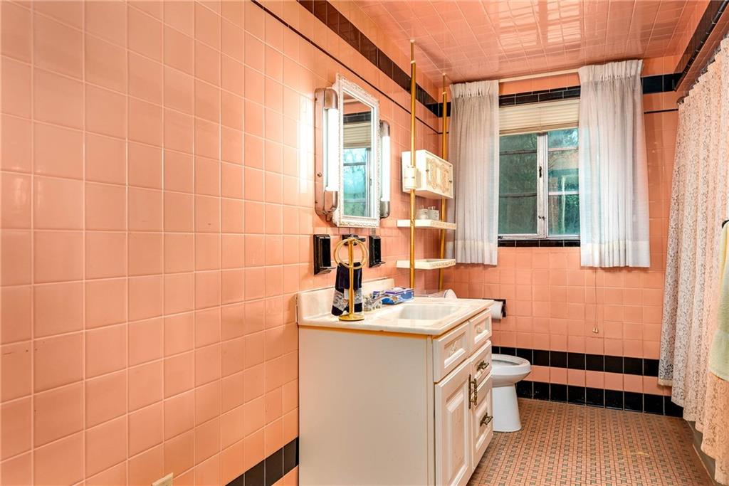 3166 Harts Run Road Glenshaw, PA 15116 - Photo 14 of 30 a bathroom with a sink a mirror and a window