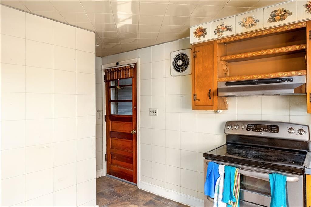 3166 Harts Run Road Glenshaw, PA 15116 - Photo 18 of 30 a stove top oven sitting inside of a kitchen