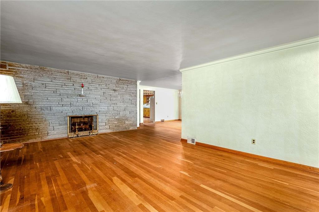 3166 Harts Run Road Glenshaw, PA 15116 - Photo 2 of 30 a view of empty room with wooden floor and fireplace