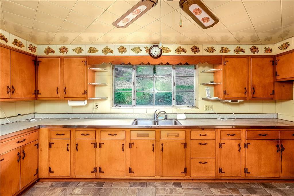 3166 Harts Run Road Glenshaw, PA 15116 - Photo 6 of 30 a view of a kitchen with granite countertop a sink and a window