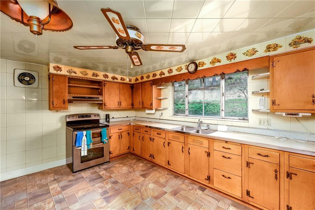 3166 Harts Run Road Glenshaw, PA 15116 - Photo 7 of 30 a kitchen with stainless steel appliances granite countertop a stove and a sink