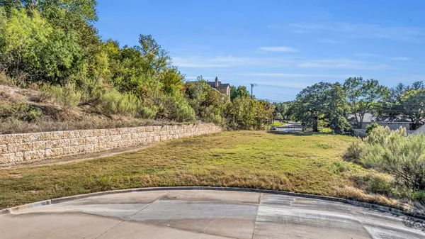 a view of yard with large trees