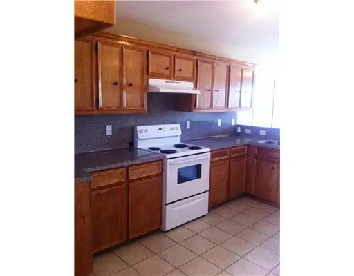 a kitchen with a sink cabinets and a window