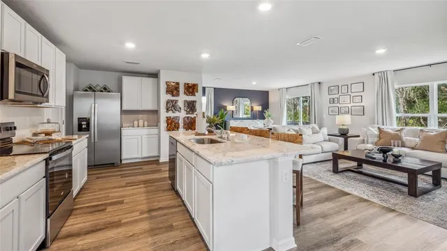 a kitchen with stainless steel appliances granite countertop a stove oven and a refrigerator