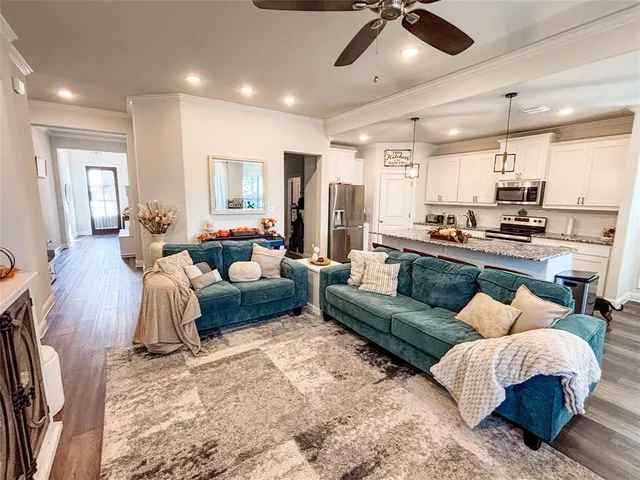 a living room with furniture and kitchen view
