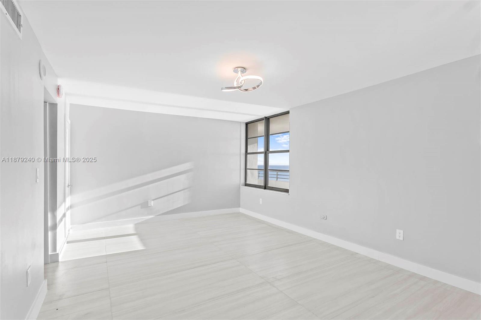 5555 Collins Avenue, Unit 14N Miami Beach, FL 33140 - Photo 6 of 16 a view of an empty room with a window